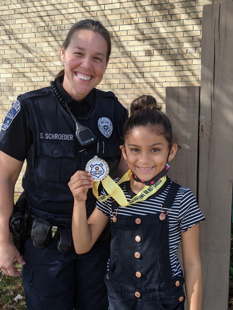 Officer Stacy and student with a medal