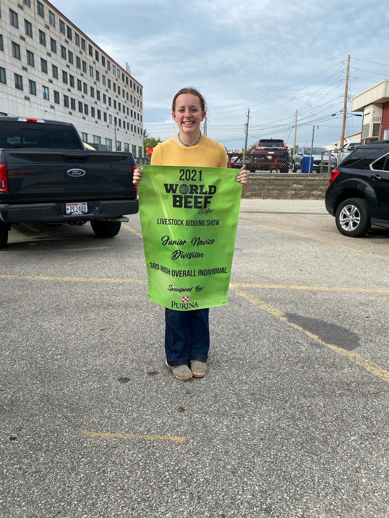 Megan holding World Beef Award Banner