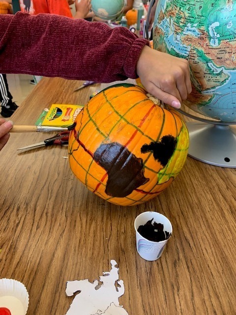 Painting a pumpkin like a globe