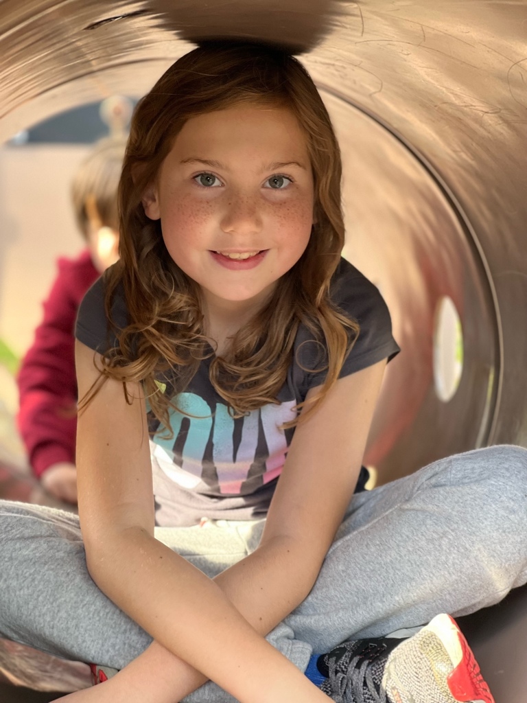 Girl in playground tunnel