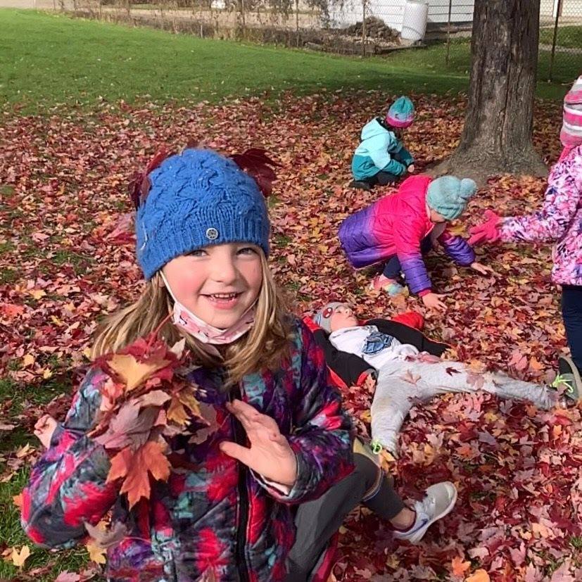 Students playing in leaves