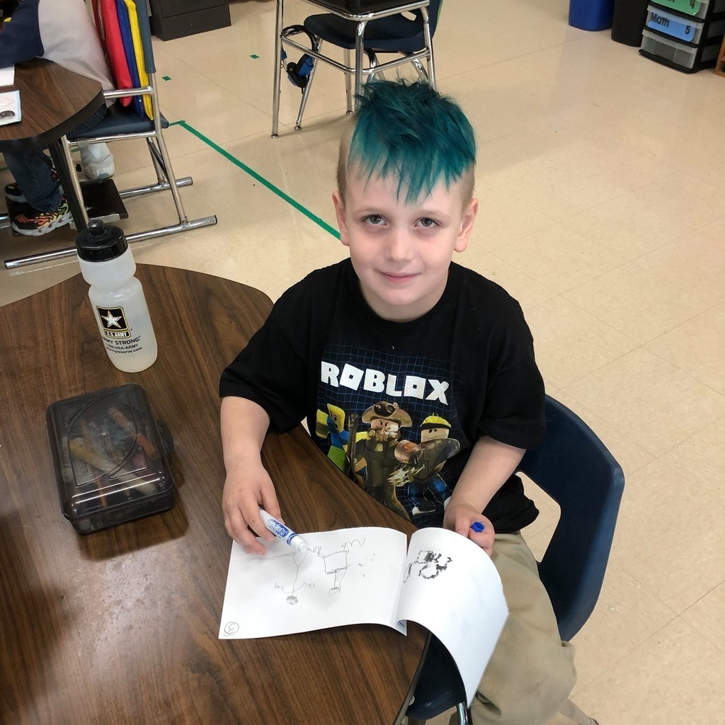 Child showing his drawing book
