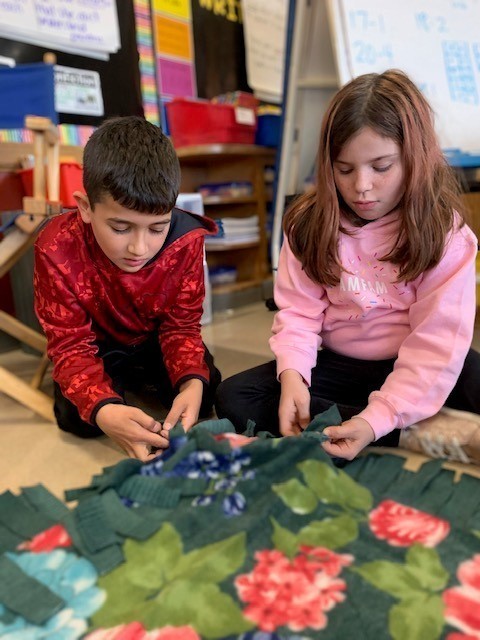 Students making a blanket