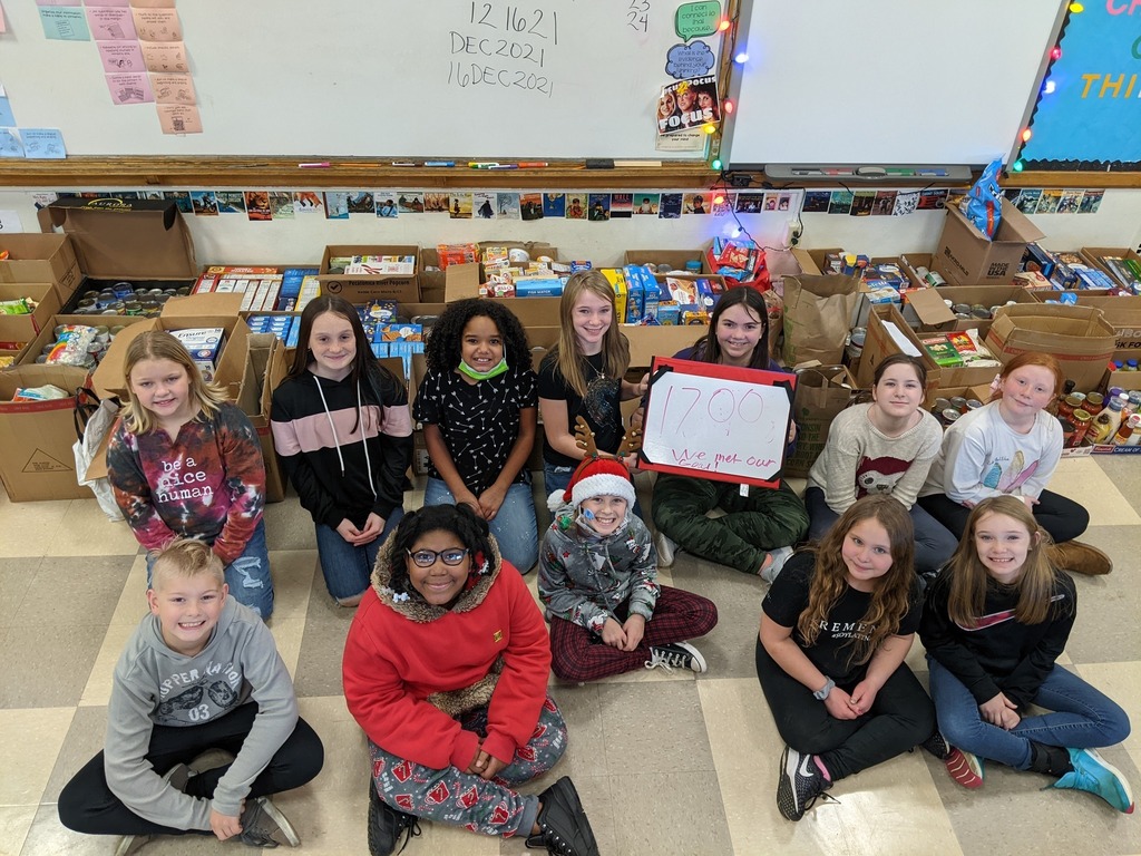 Students holding food drive sign