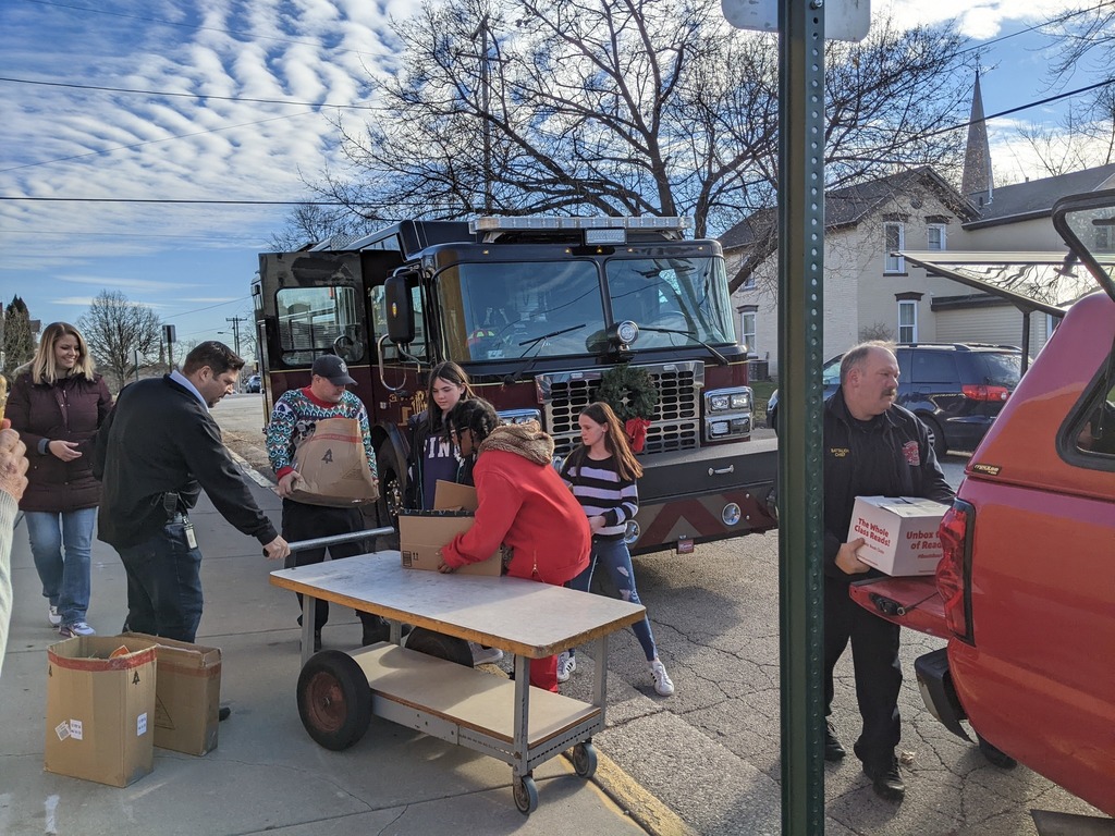 Firefighters helping students load food pantry items
