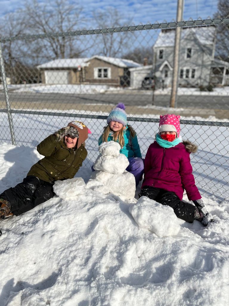 Three girls with a snowman