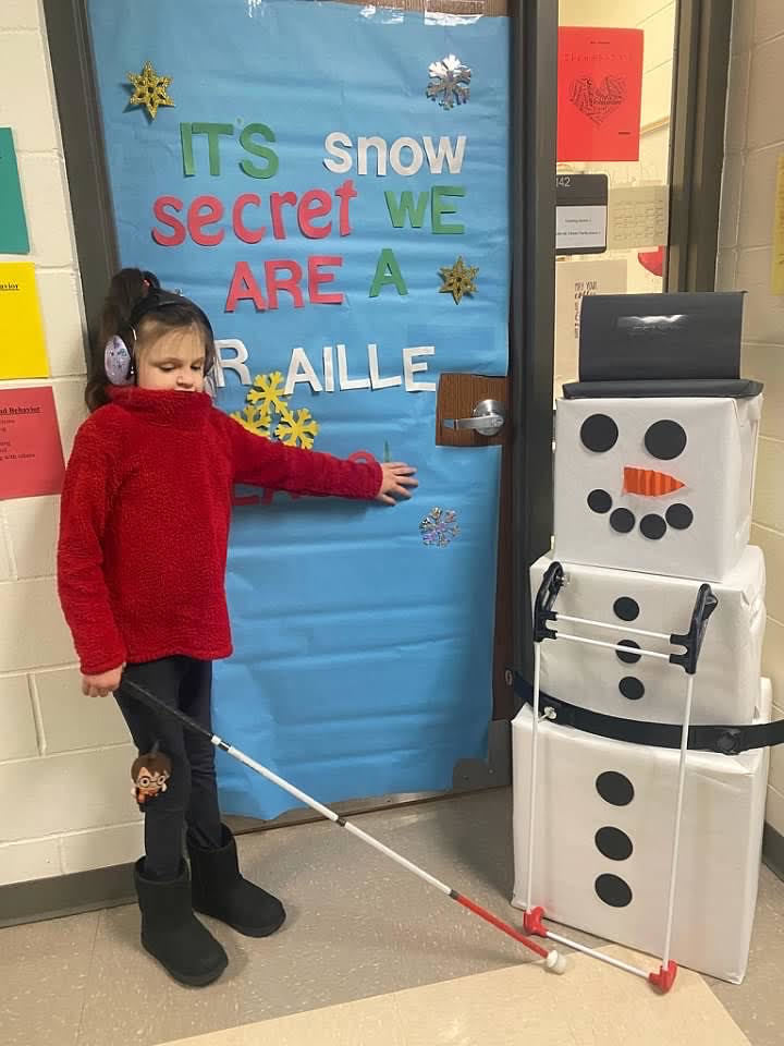 Blind student with a cardboard snowman