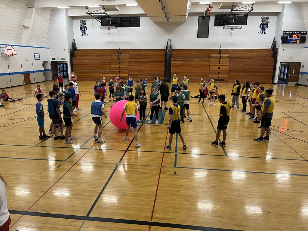 Students playing Kin-Ball in a gymnasium