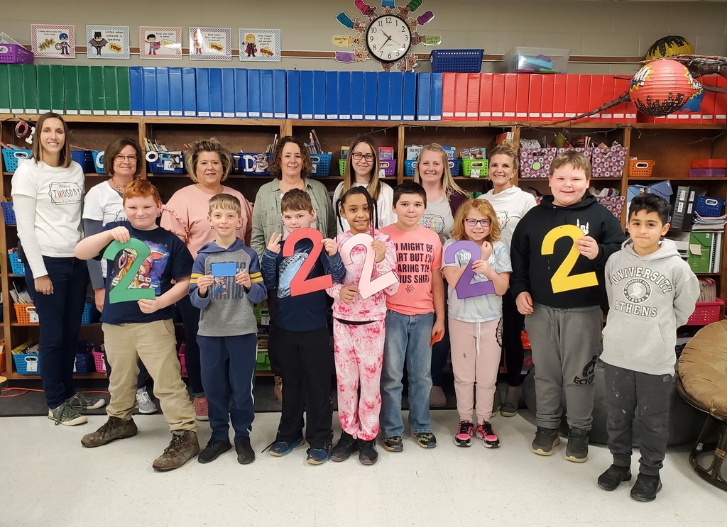 students and teachers holding "2's"
