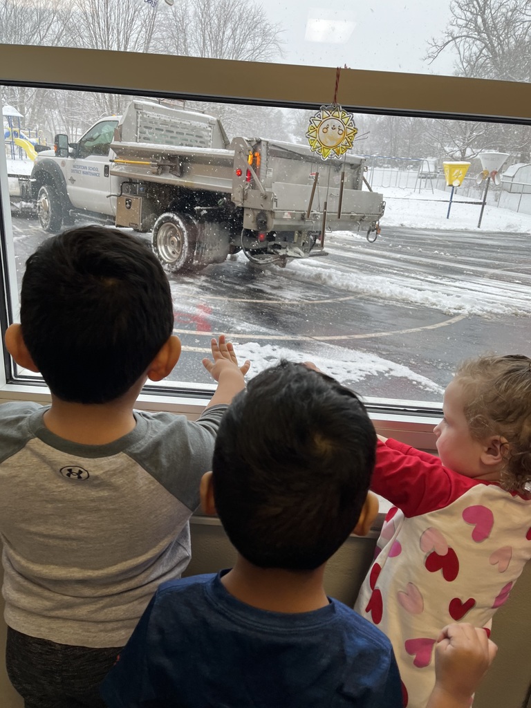 three students watching a plow out of a window