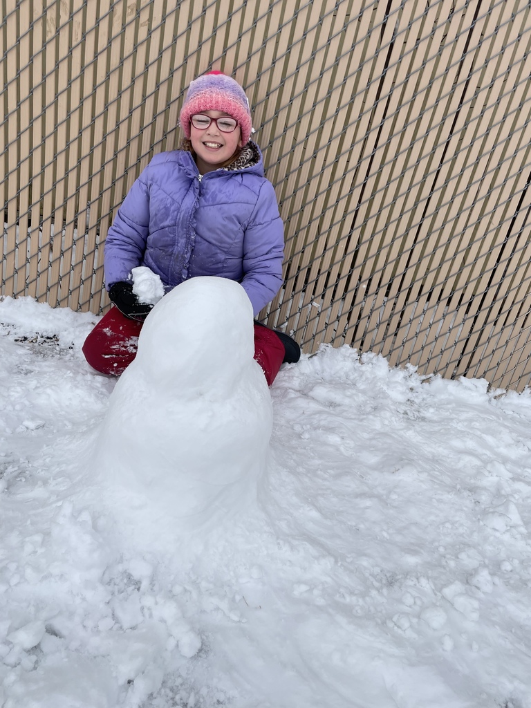 a girls building a snowman