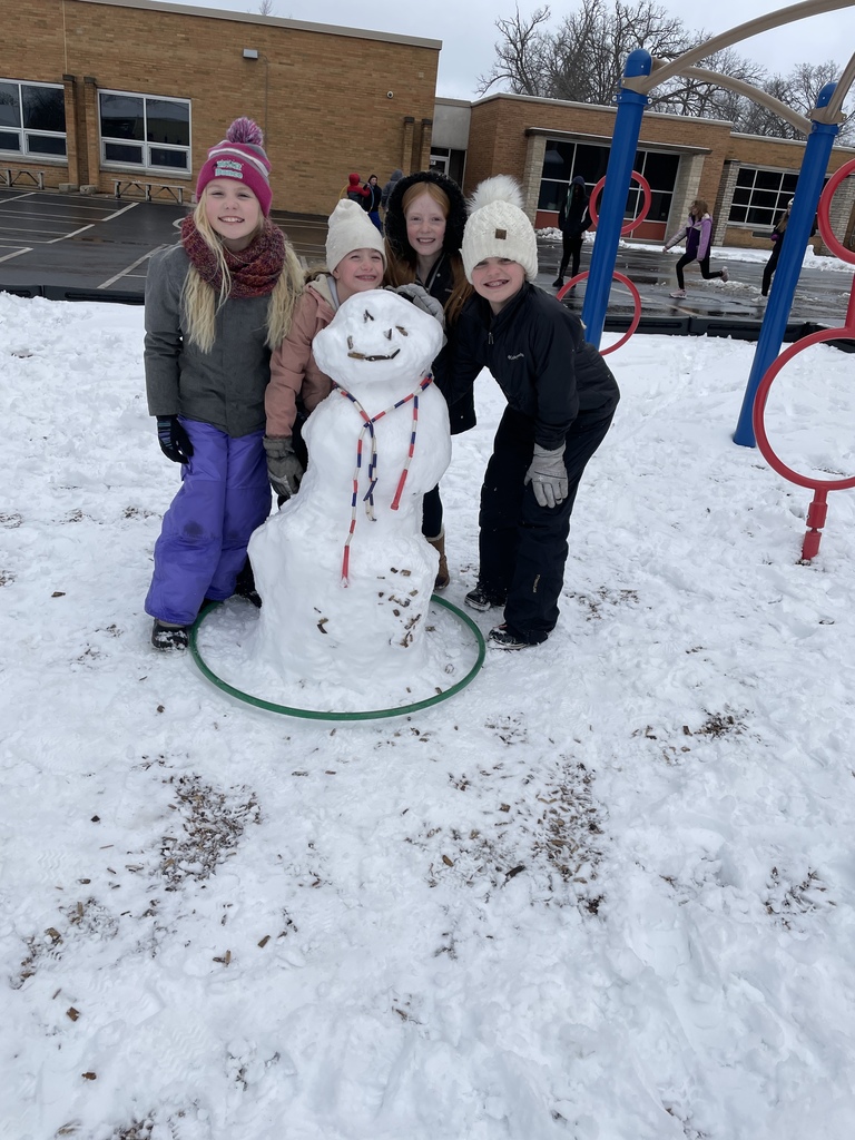 four girls building a snowman