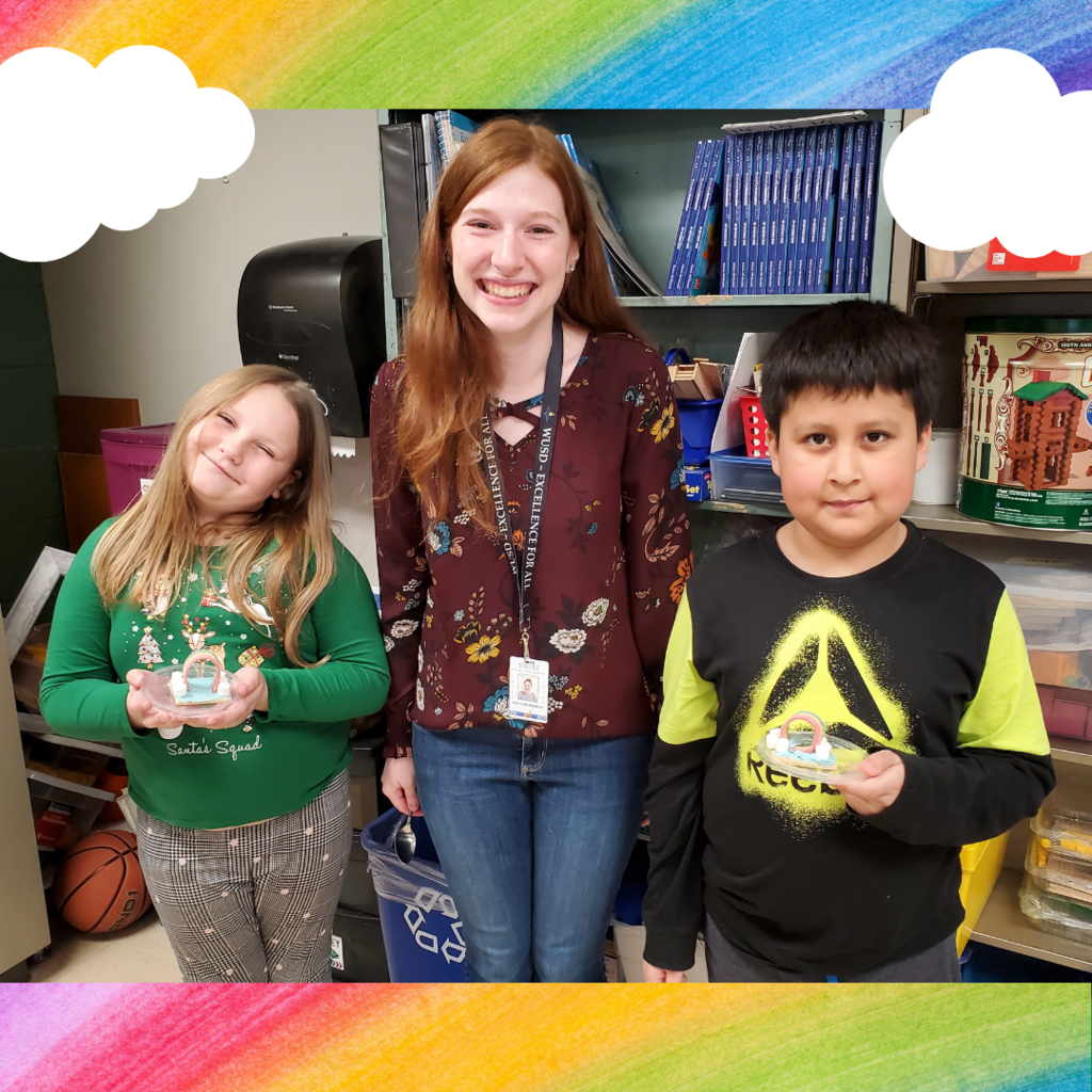 Students showing their rainbow snacks with a student teacher
