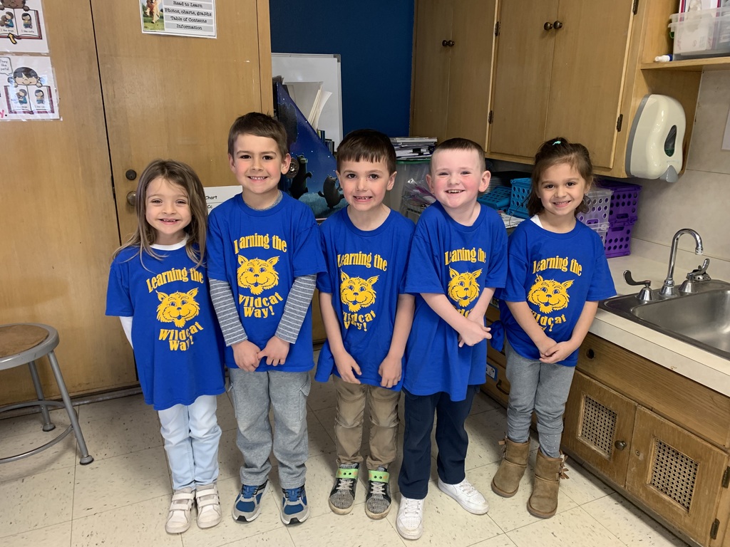 5 students wearing their school t-shirts