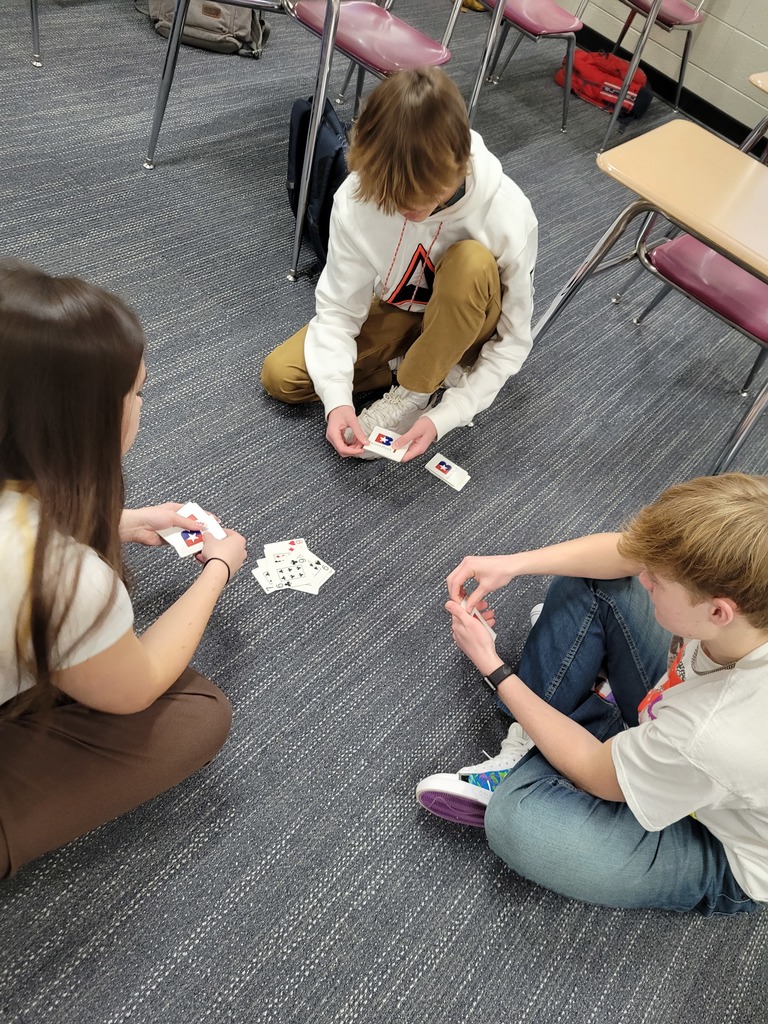 Three students playing cards
