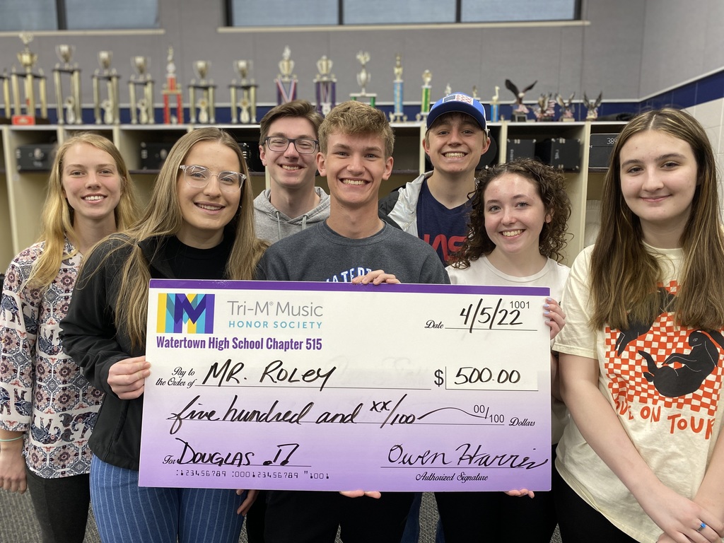 Students donating a big check