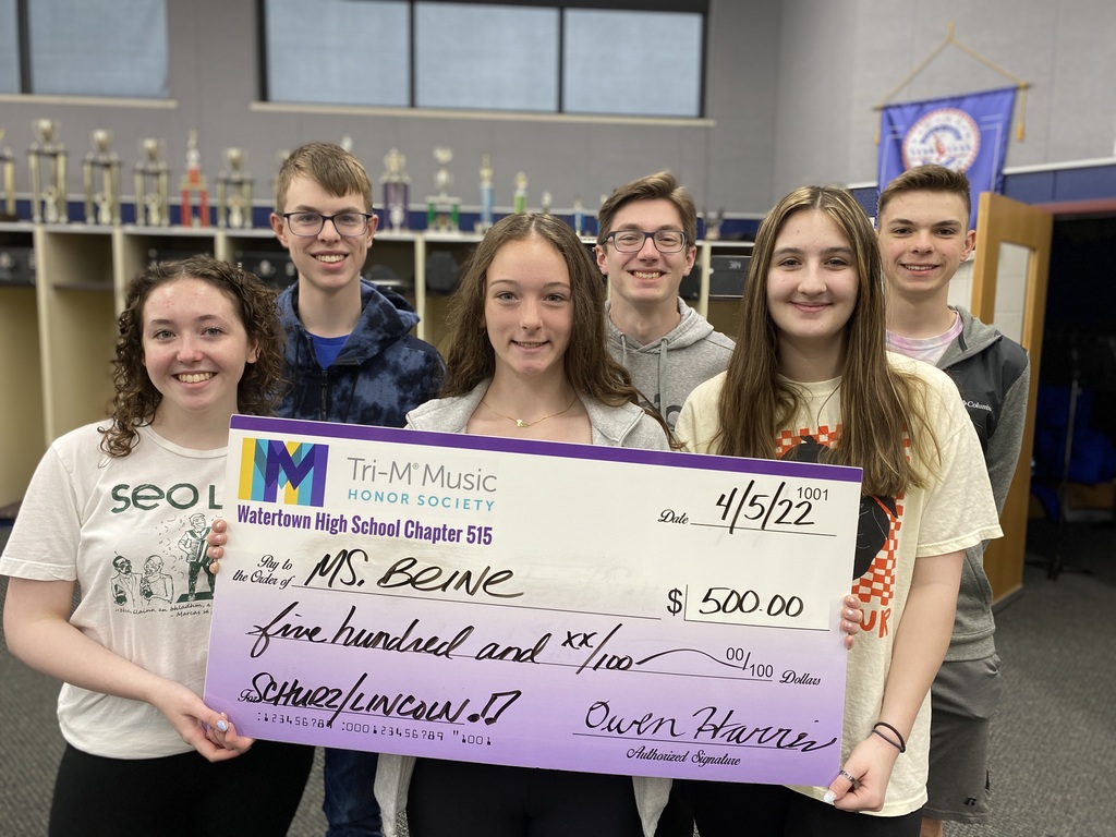 Students donating a big check