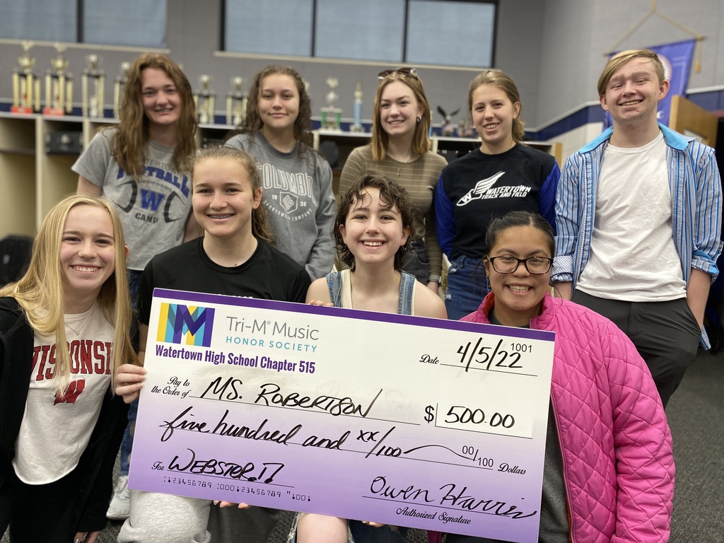 Students donating a big check