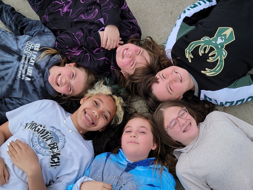 Students lying around in a circle