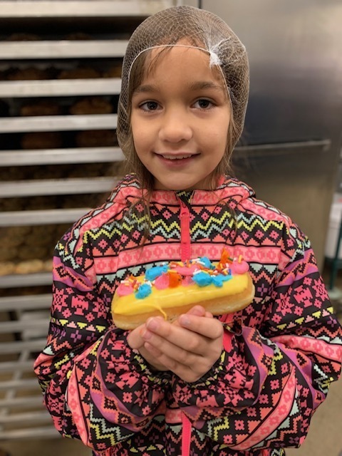 a girl with a donut