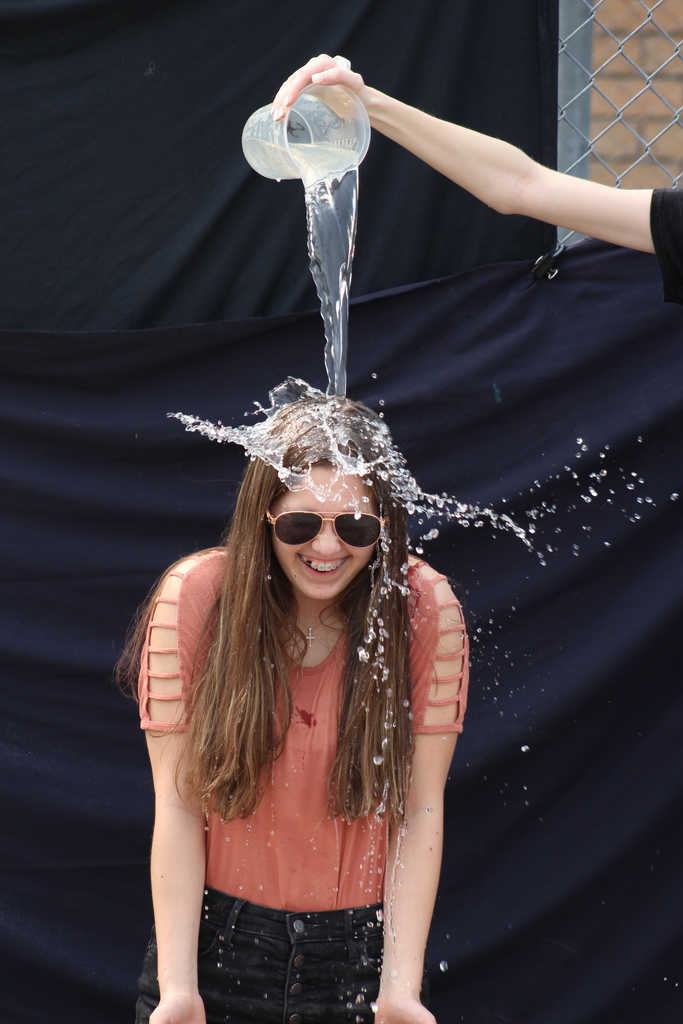 Girl getting water poured on her head