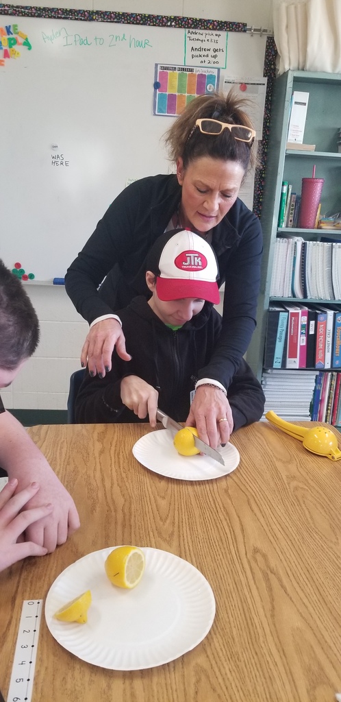 student and teacher cutting a lemon