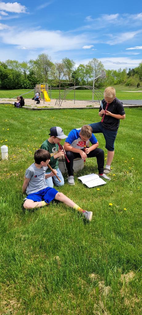 Students playing recorders outside