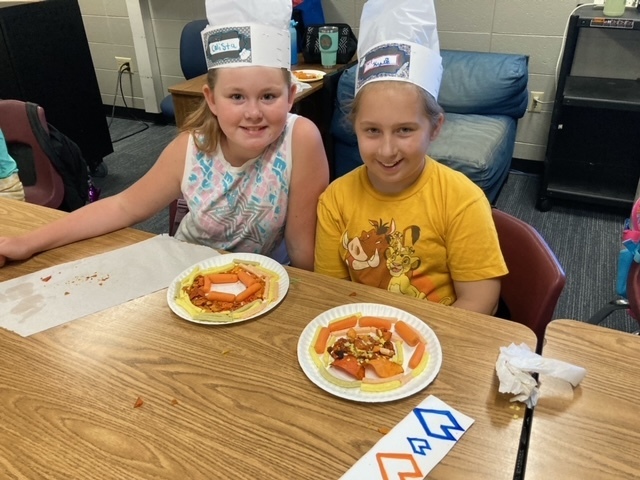students in chef hats with ratatouille