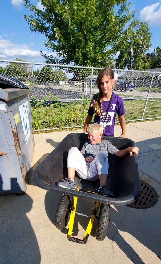 Two students with a wheelbarrow
