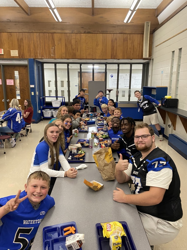 athletes eating with students