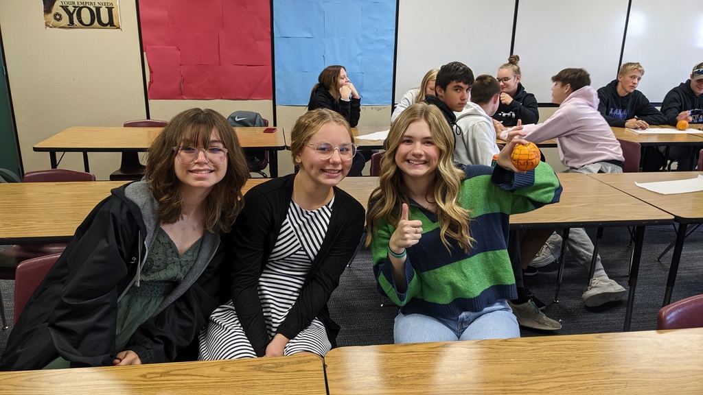 Three students with an orange