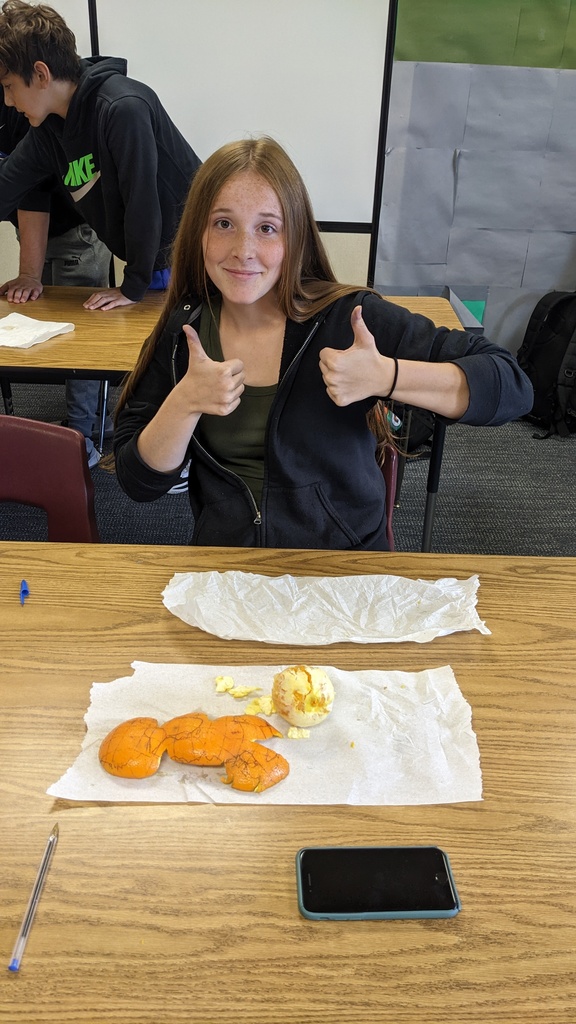 student with a peeled orange