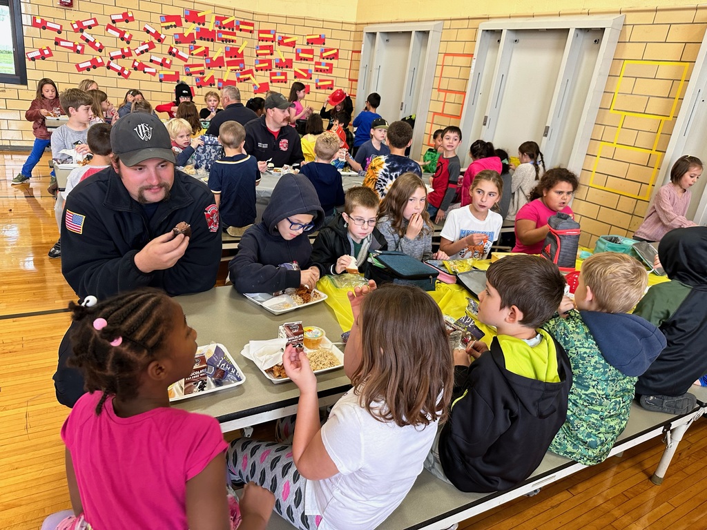 Firefighters eating lunch with students