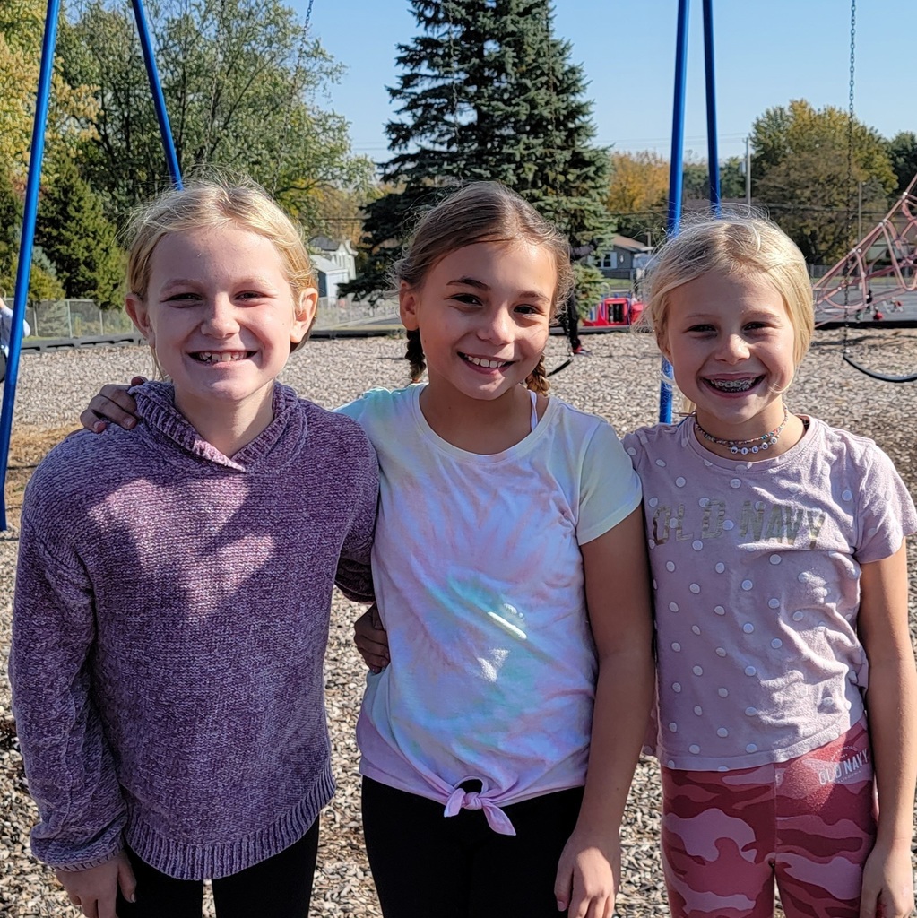 three students on the playground