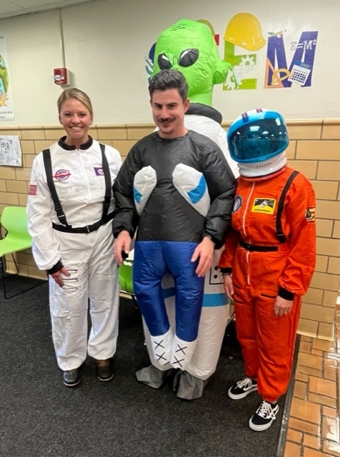 Staff dressed as astronauts and an alien