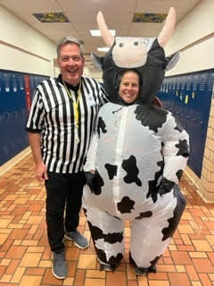 staff dressed as a cow and referee