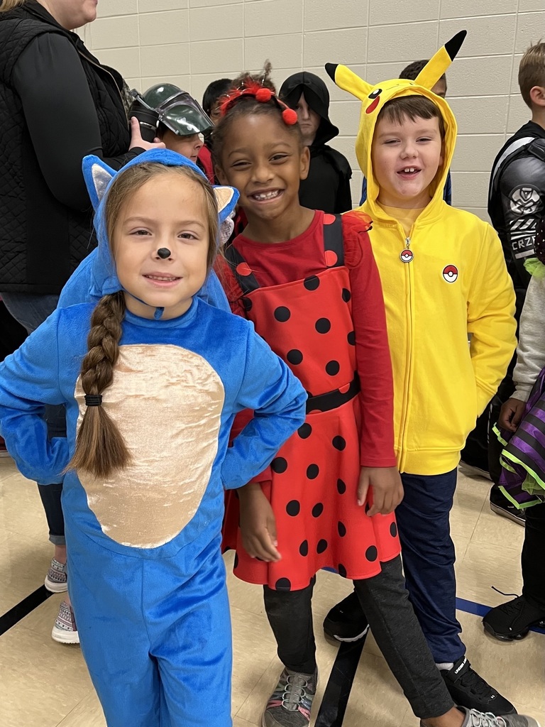 three students dressed up in costumes