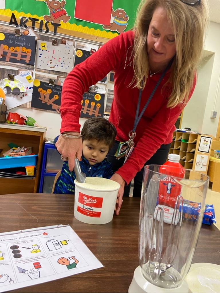 teacher helping a student make a shake