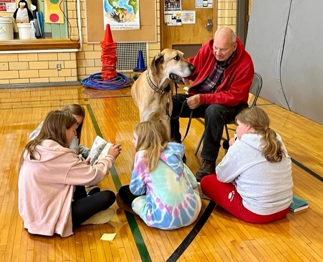 Students reading to a dog
