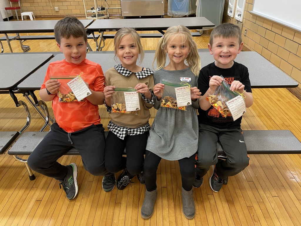 four students with treat bags